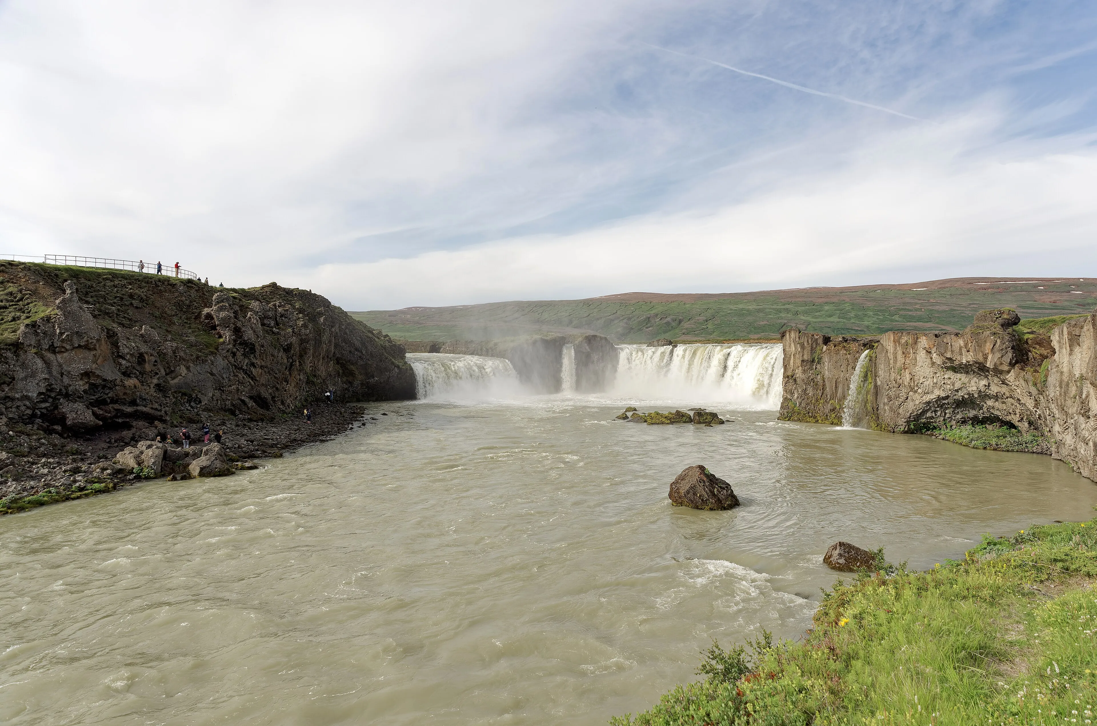 Godafoss waterfall curving through a rugged Icelandic landscape