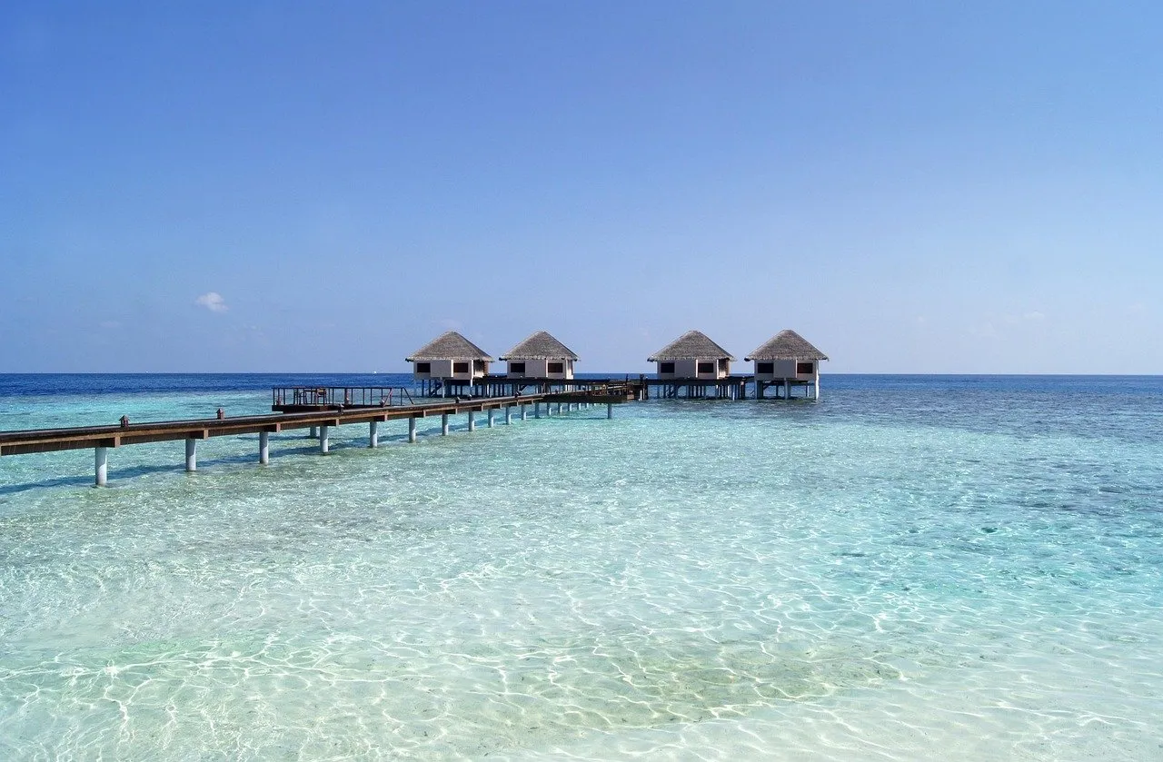 Overwater villas on stilts above a turquoise Maldivian lagoon