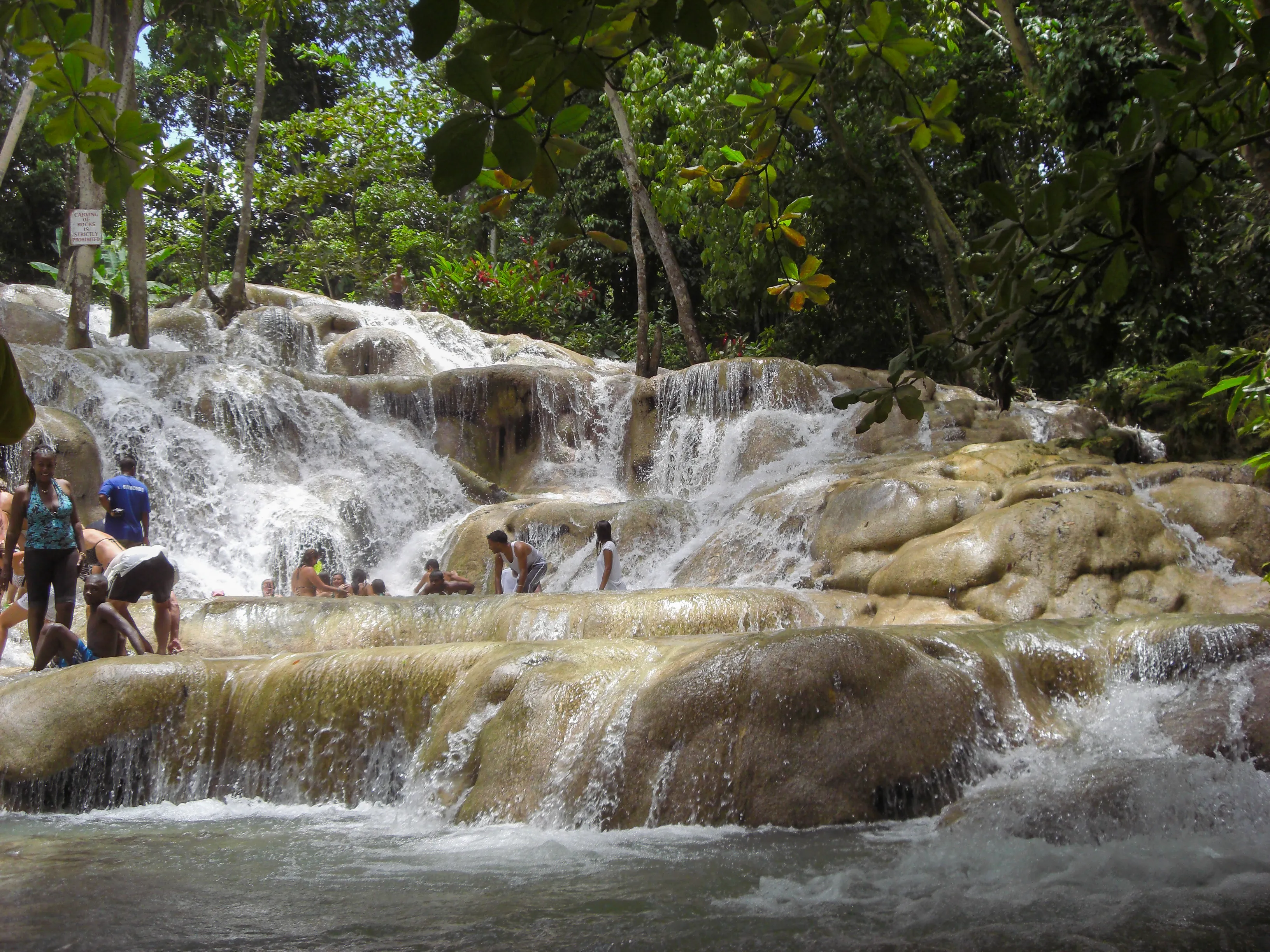 Visitors climbing the terraced cascades of Dunn’s River Falls in Ocho Rios, Jamaica